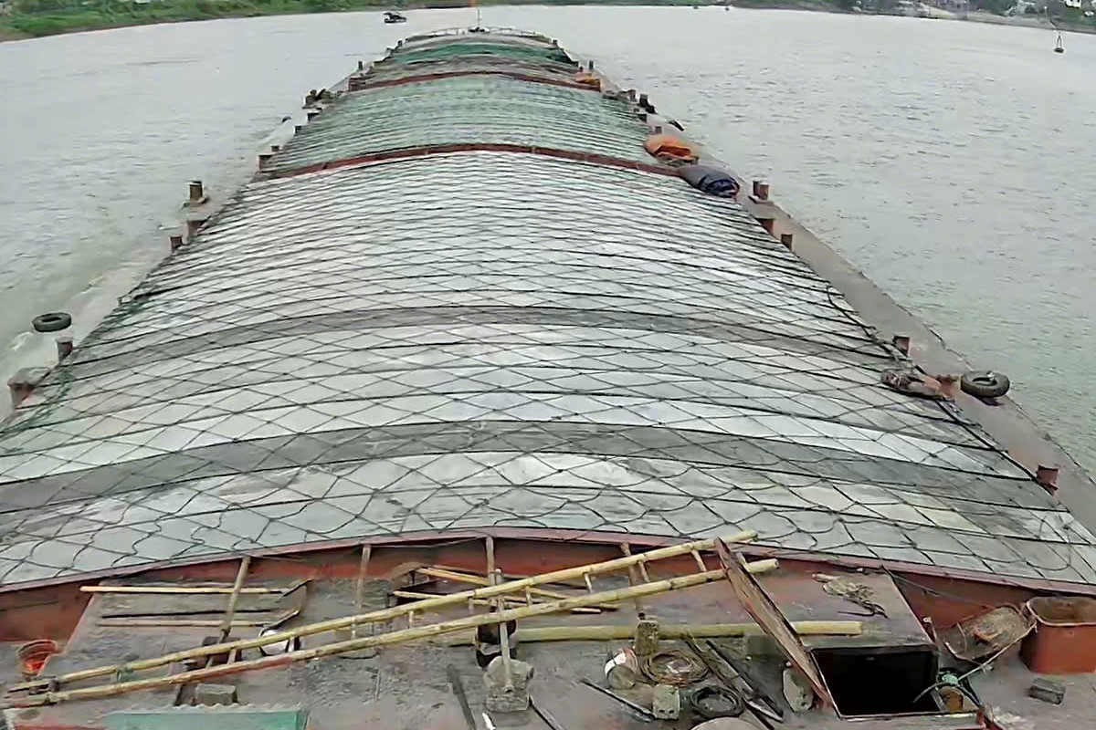 Thanh Phat barge tow under way with netted cargo